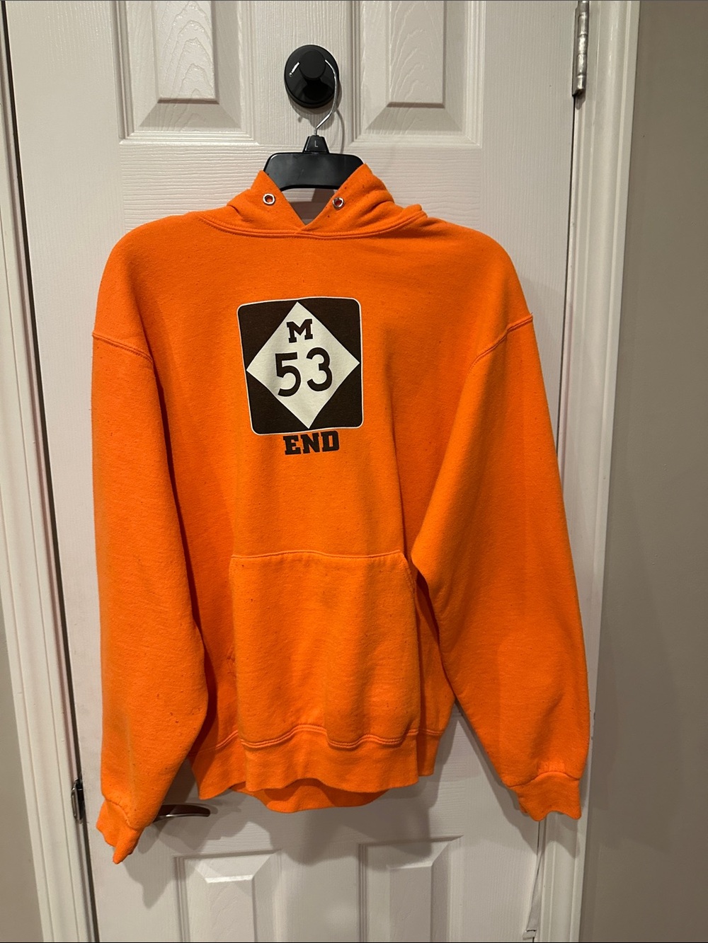 The Jetset Diaries Orange Hoodie with Black & White 'M 53 END' Graphic